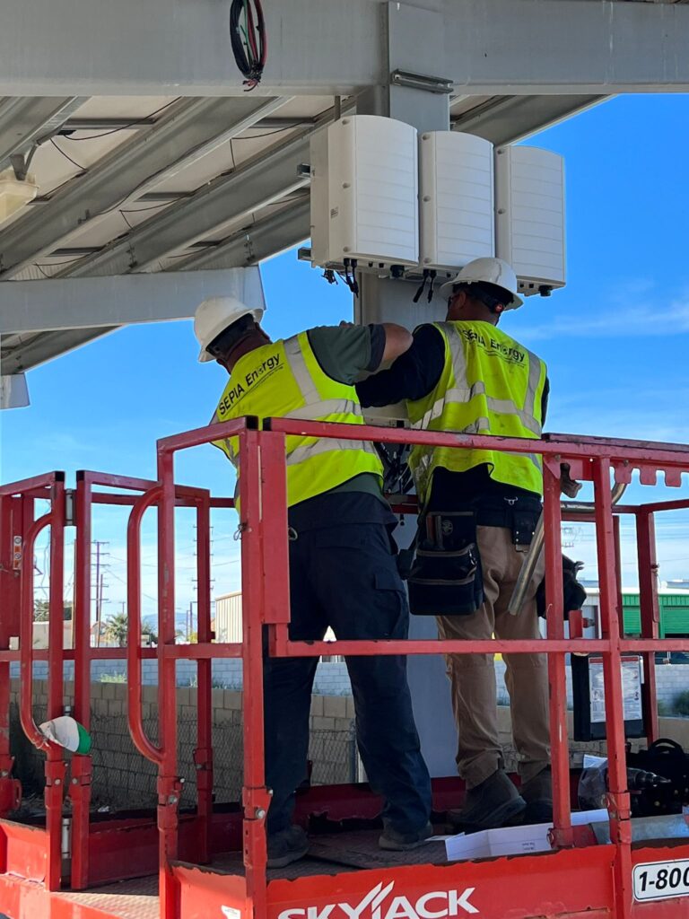 Vertical view showing the large solar carport array and repowering work in progress.