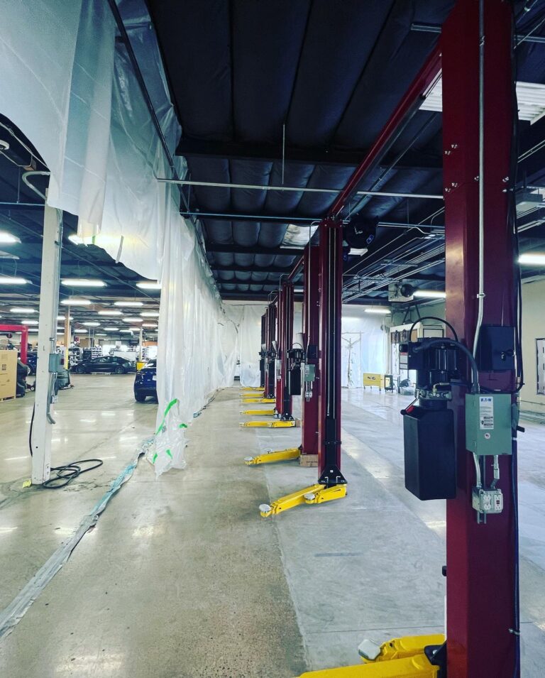 Electrical conduit, junction boxes, and wiring being run in the service center ceiling.